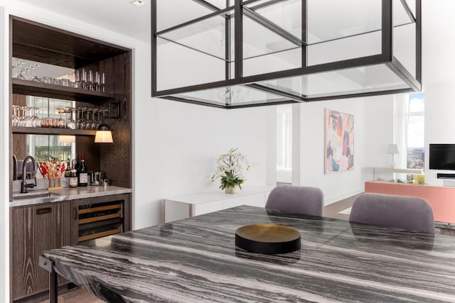 bar featuring dark brown cabinets and sink