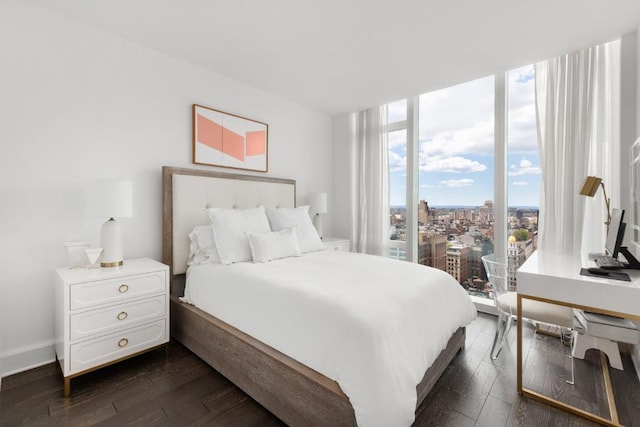 bedroom featuring dark wood-type flooring and floor to ceiling windows