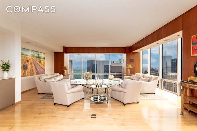 641 5th Ave Unit 49Cde, New York City, NY 10022 - living room with a view of skyline and light wood-type flooring