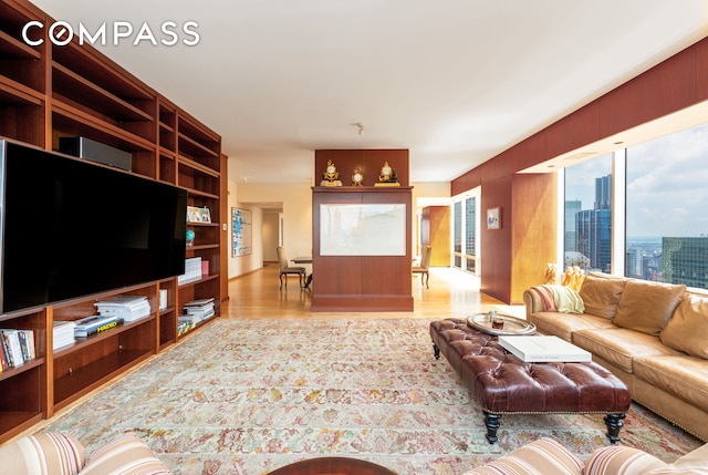 641 5th Ave Unit 49Cde, New York City, NY 10022 - living room with wood finished floors and a city view