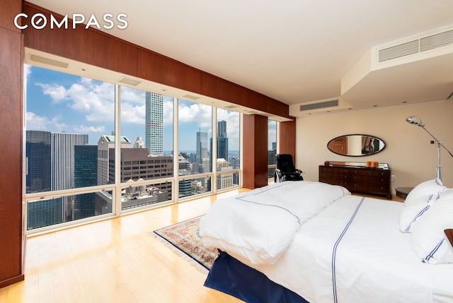 641 5th Ave Unit 49Cde, New York City, NY 10022 - bedroom with wood finished floors, a skyline view, and access to outside