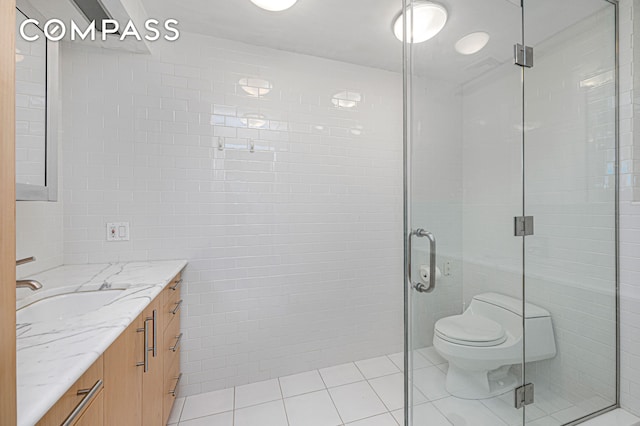 641 5th Ave Unit 49Cde, New York City, NY 10022 - full bathroom with tile walls, vanity, tile patterned flooring, and a stall shower