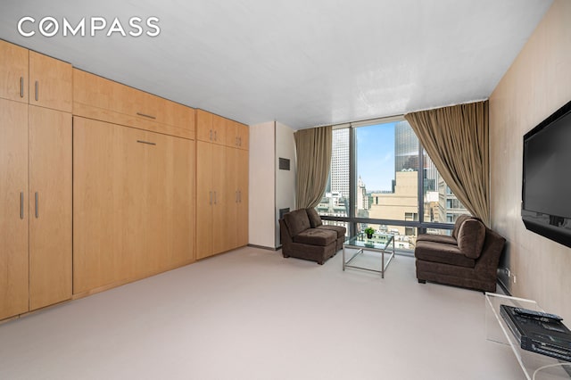 641 5th Ave Unit 49Cde, New York City, NY 10022 - carpeted living area featuring a wall of windows