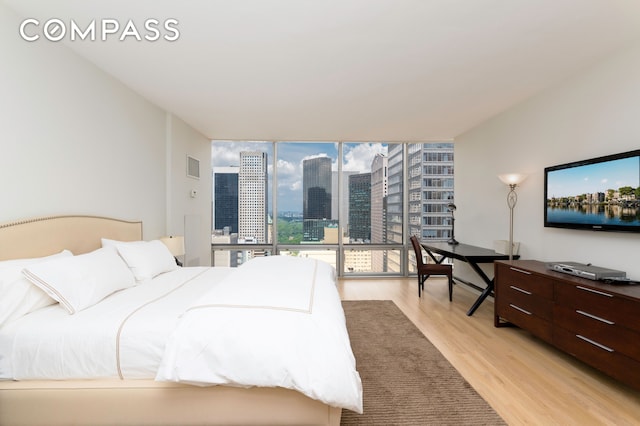 641 5th Ave Unit 49Cde, New York City, NY 10022 - bedroom featuring light wood-style flooring and expansive windows