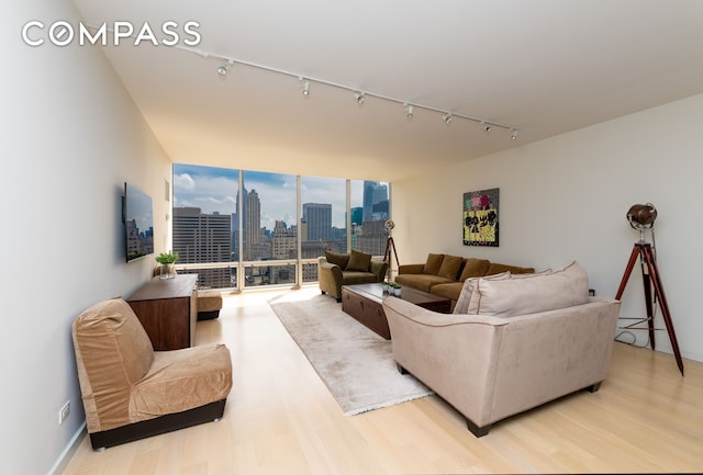 641 5th Ave Unit 49Cde, New York City, NY 10022 - living room with rail lighting and light wood finished floors