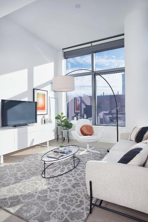 living room featuring wood-type flooring and a healthy amount of sunlight