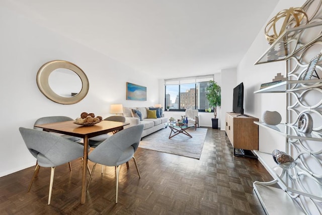 dining room with expansive windows and dark parquet floors