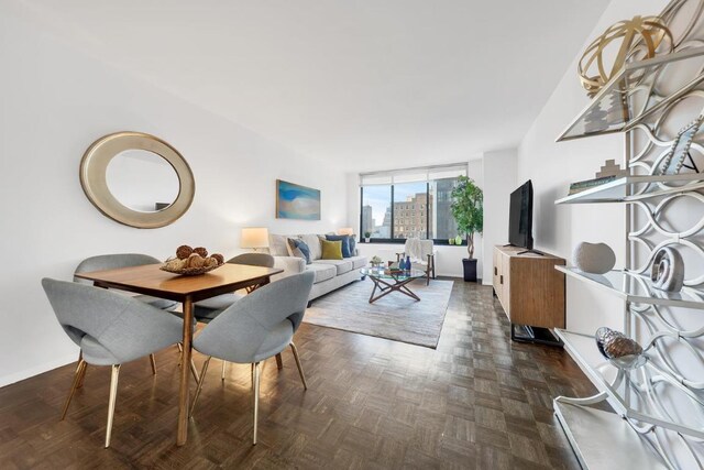 dining room with expansive windows and dark parquet floors