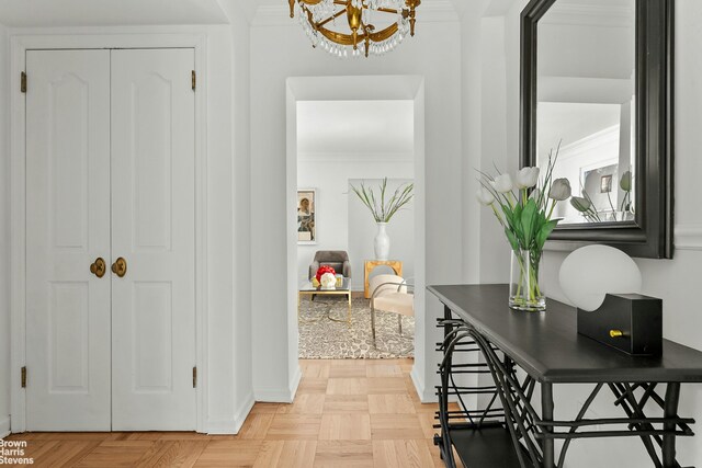 169 E 69th St Unit 2B, New York City, NY 10021 - hall with a chandelier, ornamental molding, and baseboards