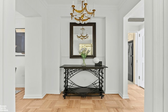 hall featuring baseboards, visible vents, a chandelier, and crown molding