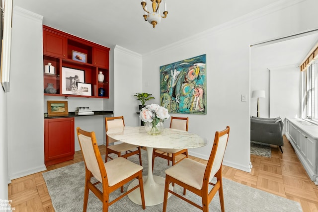169 E 69th St Unit 2B, New York City, NY 10021 - dining area with ornamental molding, baseboards, and a chandelier