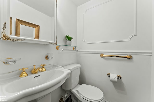 169 E 69th St Unit 2B, New York City, NY 10021 - half bathroom with toilet and a sink