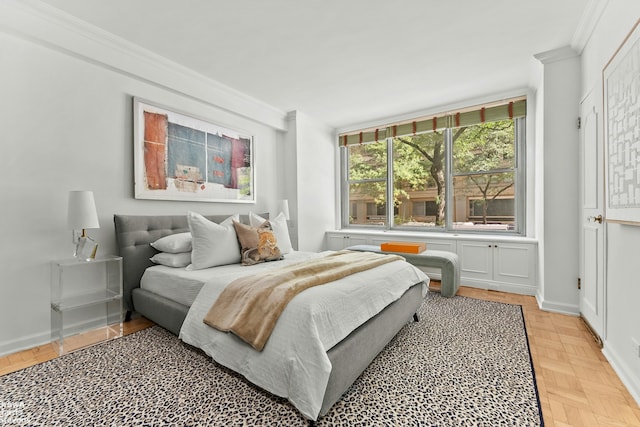 bedroom with ornamental molding and baseboards