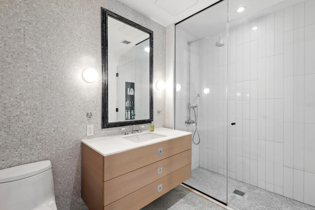 bathroom featuring visible vents, toilet, tile walls, and a tile shower