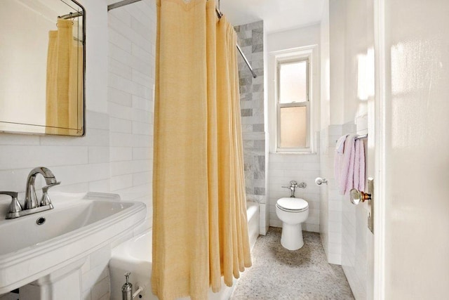 full bathroom featuring toilet, sink, tile walls, and shower / bath combo