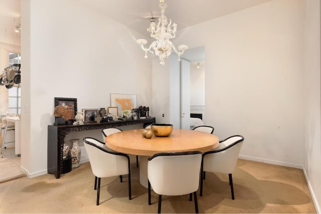 carpeted dining area featuring an inviting chandelier