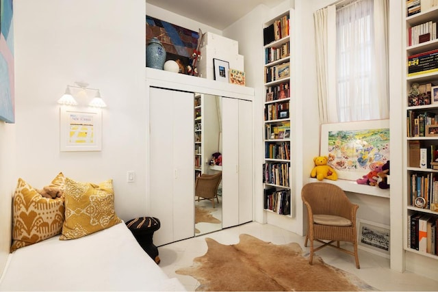 tiled bedroom featuring a closet