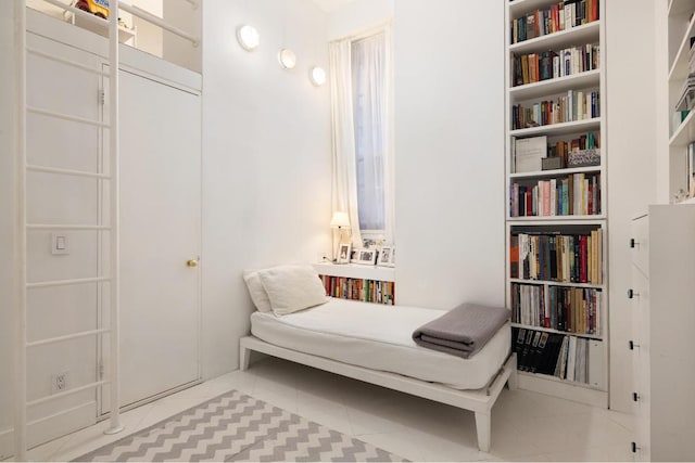 sitting room featuring light tile patterned floors and built in features