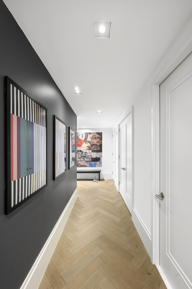 corridor featuring baseboards and recessed lighting