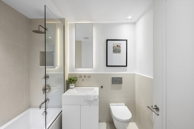 full bath with toilet, shower / bath combination, tile walls, and vanity