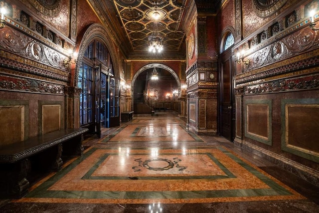 corridor with crown molding and a towering ceiling