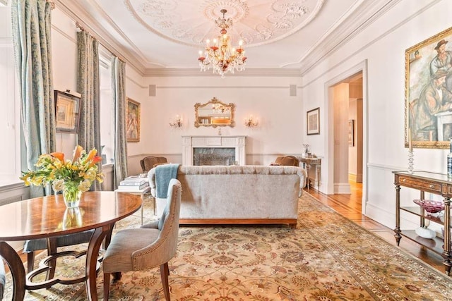 tiled living room featuring a raised ceiling, crown molding, and a chandelier