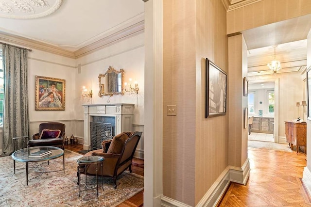 sitting room featuring parquet floors, a fireplace, and ornamental molding