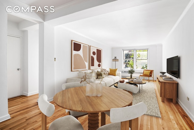 dining space with baseboards, light wood finished floors, and crown molding