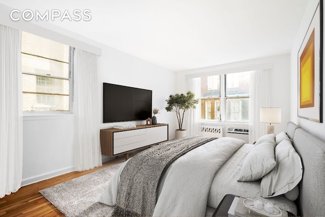 bedroom featuring multiple windows and hardwood / wood-style floors