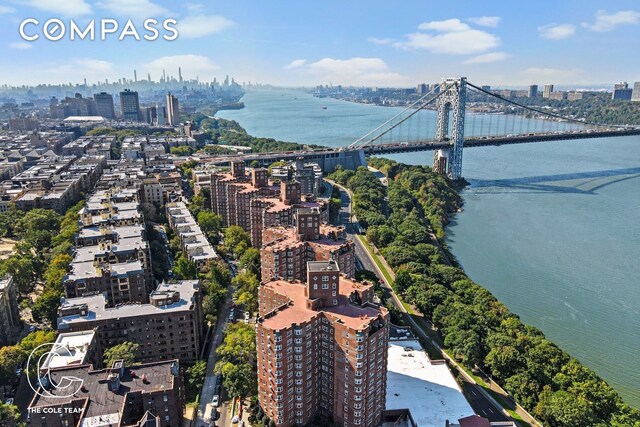 drone / aerial view featuring a view of city and a water view