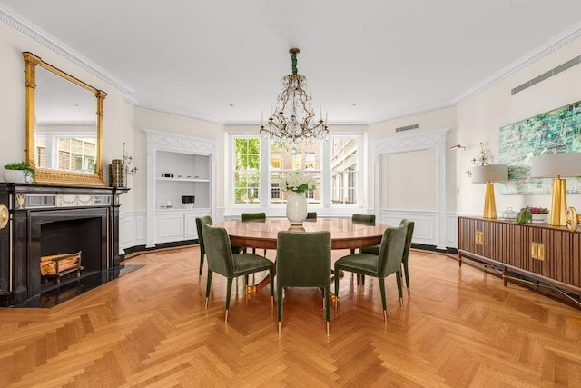 dining room featuring light parquet flooring, crown molding, and a notable chandelier