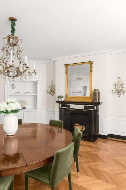 dining space featuring light parquet floors, ornamental molding, and built in features