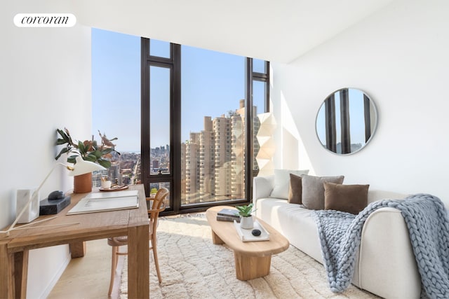living area with plenty of natural light, a city view, floor to ceiling windows, and visible vents