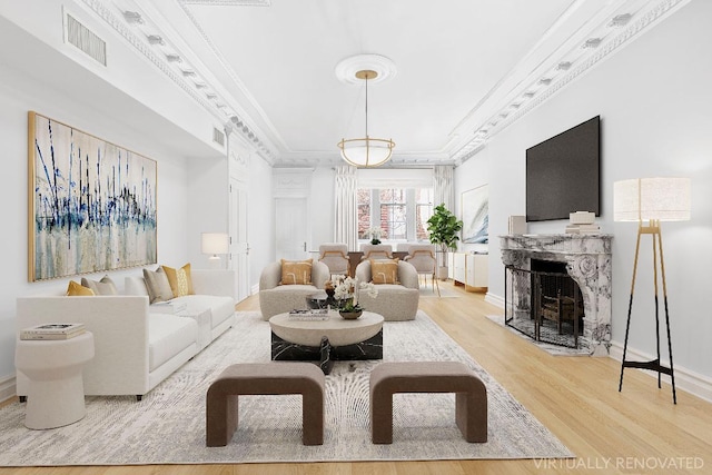 living room featuring wood-type flooring and ornamental molding