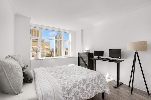 bedroom with light hardwood / wood-style flooring and crown molding