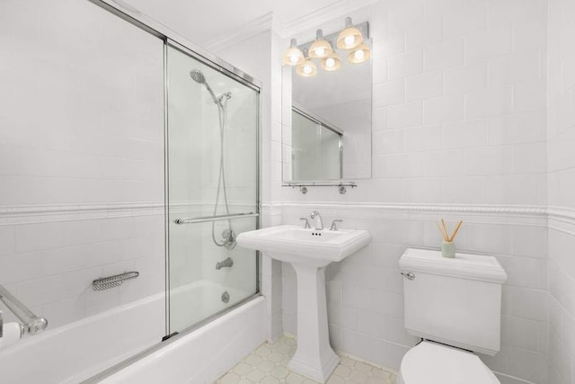 bathroom featuring toilet, ornamental molding, and enclosed tub / shower combo