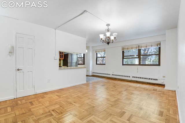 interior space featuring a baseboard radiator, a notable chandelier, and light parquet floors