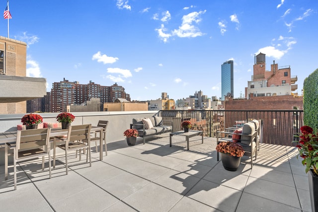 view of patio with a view of city and outdoor dining area