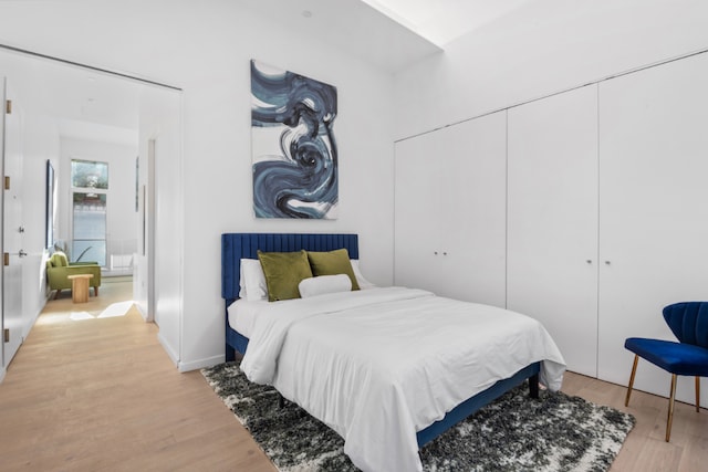 bedroom featuring a closet and light hardwood / wood-style flooring