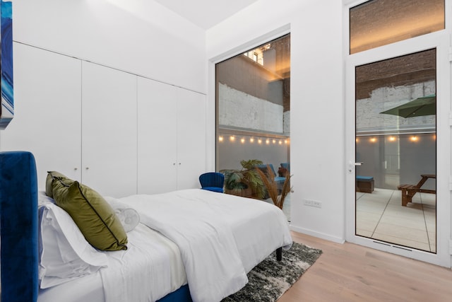 bedroom featuring a closet and light wood-style floors