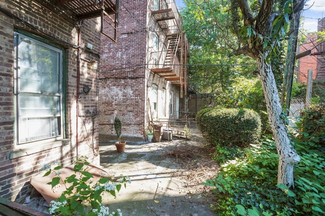 view of home's exterior featuring brick siding and a patio area