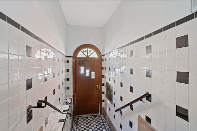 foyer with tile walls