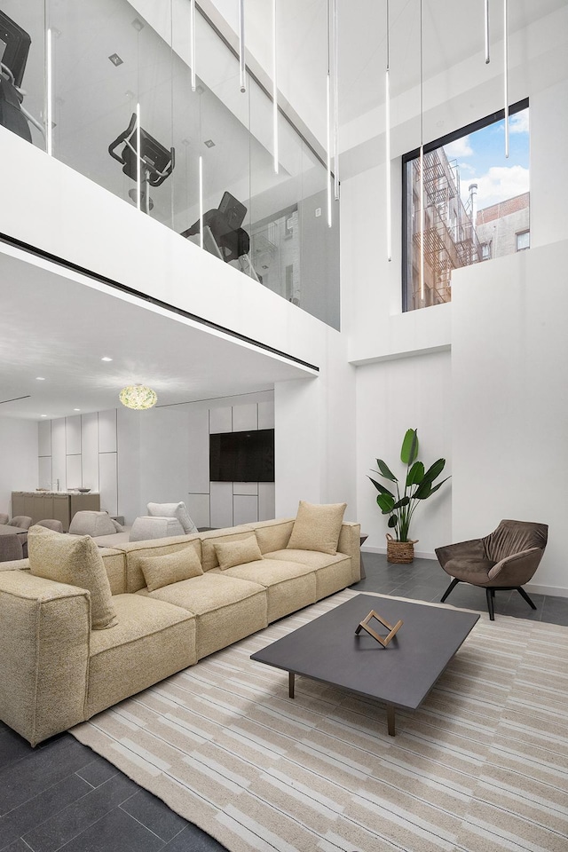 living room featuring a towering ceiling