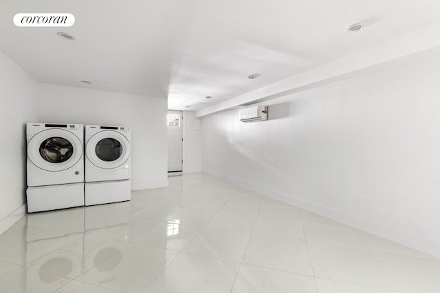 laundry area featuring baseboards, visible vents, a wall mounted AC, light tile patterned flooring, and independent washer and dryer