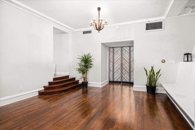1 W 67th St Unit 2E, New York City, NY 10023 - empty room with a chandelier, wood finished floors, baseboards, and stairway