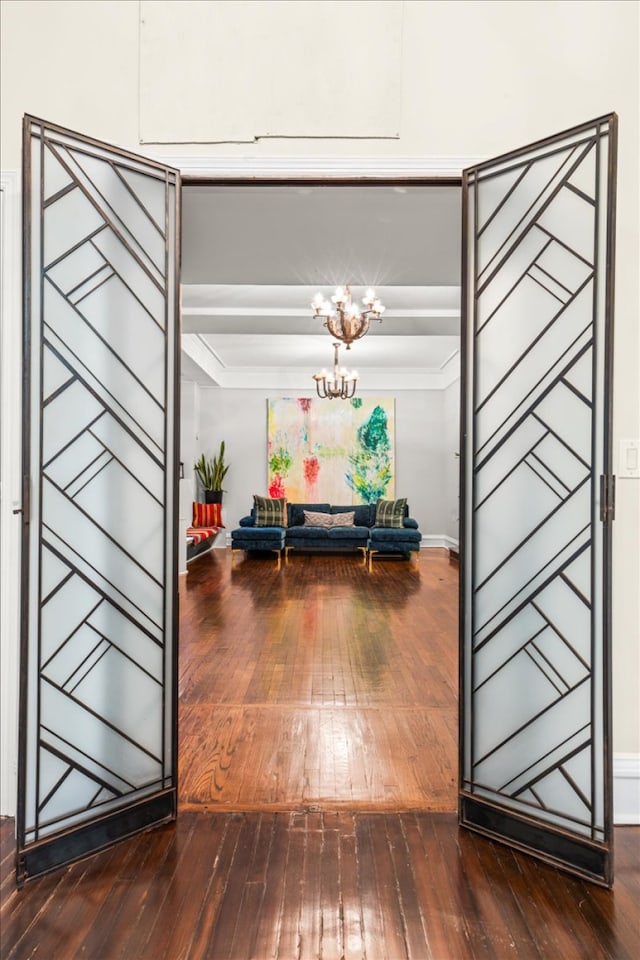 1 W 67th St Unit 2E, New York City, NY 10023 - hallway with hardwood / wood-style floors, a chandelier, ornamental molding, and baseboards