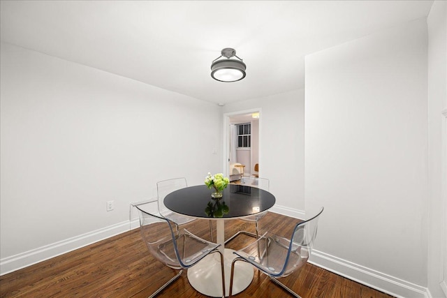 1 W 67th St Unit 2E, New York City, NY 10023 - dining space featuring baseboards and wood finished floors