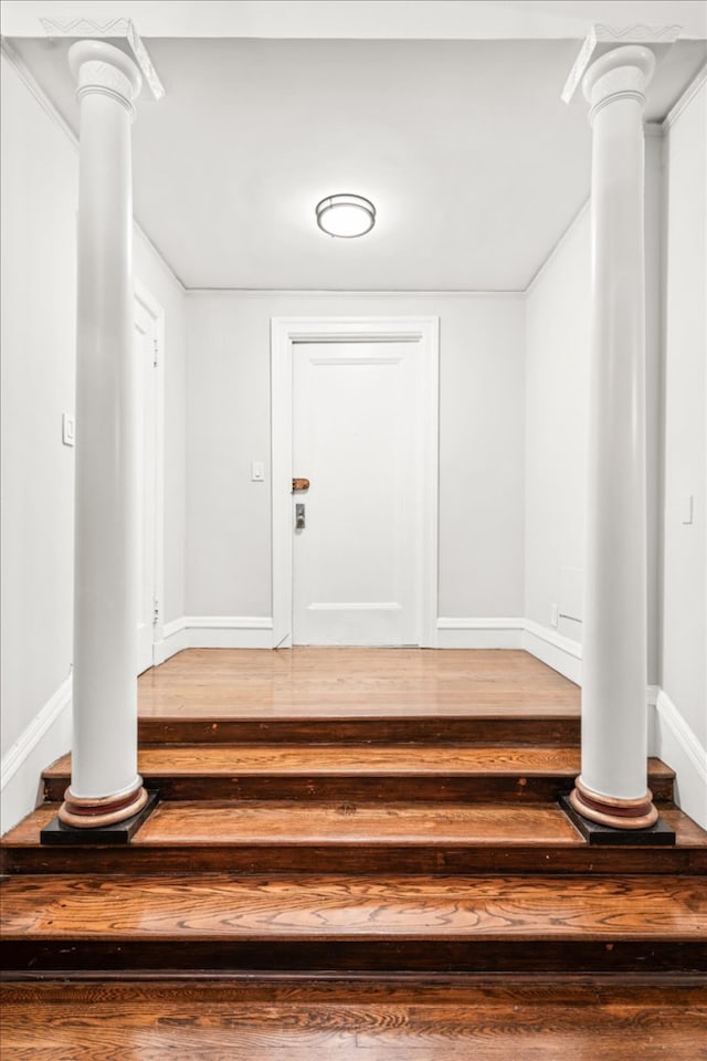 1 W 67th St Unit 2E, New York City, NY 10023 - foyer entrance with wood finished floors, baseboards, and decorative columns