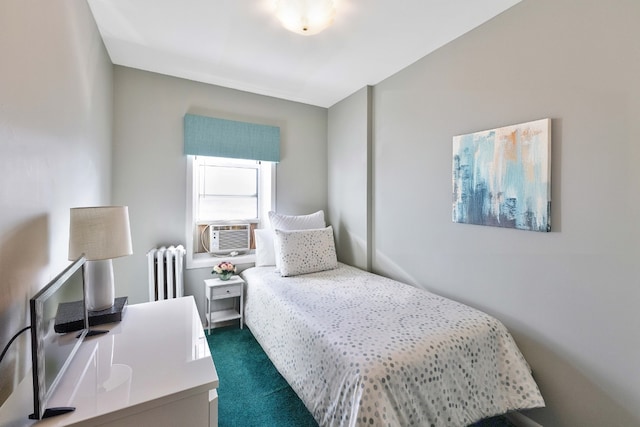 bedroom featuring radiator heating unit, dark carpet, and cooling unit