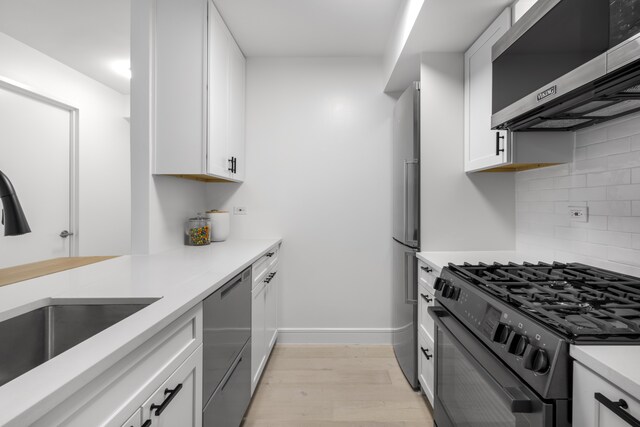 kitchen featuring stainless steel microwave, range with gas cooktop, and white cabinets